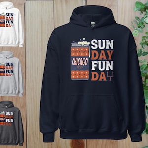 May include: A navy blue hoodie with the text "SUN DAY FUN DAY CHICAGO 1920" in white and orange. The design includes a beer can graphic. Additional hoodies in white, gray, and charcoal are also shown.