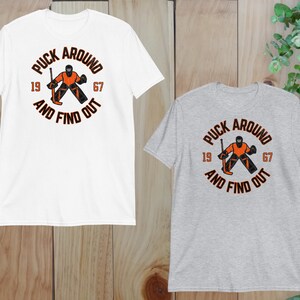 two t - shirts on a wooden background