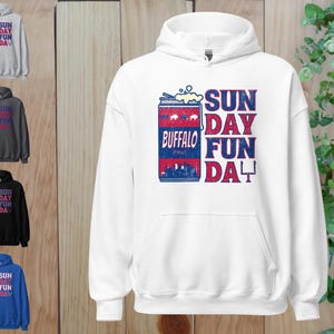 May include: White hooded sweatshirt with a blue and red graphic of a can of Buffalo beer with the text "Sun Day Fun Da" printed on the front.