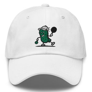 May include: White baseball cap with an embroidered green pickle character wearing a white baseball cap and holding a black tennis racket.