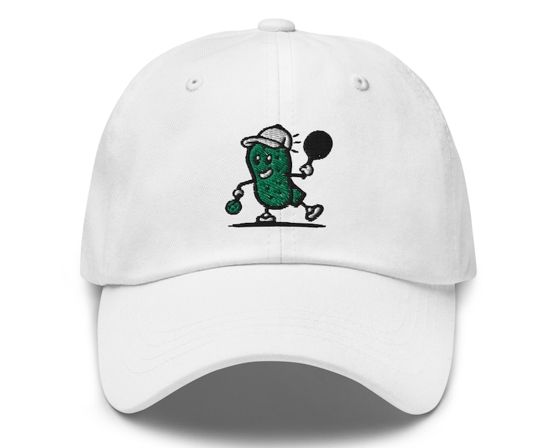 May include: White baseball cap with an embroidered green pickle character wearing a white baseball cap and holding a black tennis racket.