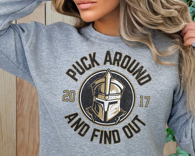 a woman wearing a sweatshirt that says puck around and find out