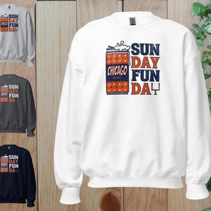 May include: White sweatshirt with the text "SUN DAY FUN DAY" in blue and red. The design includes a graphic of a can with the text "CHICAGO" and a football field. Three other sweatshirts in gray, charcoal, and navy are also shown.