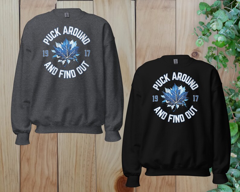 a couple of sweatshirts sitting on top of a wooden floor