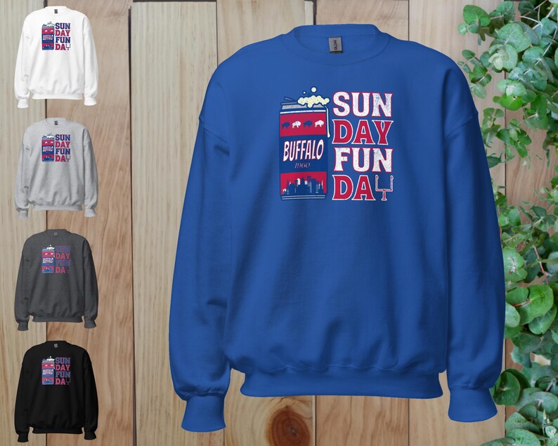 May include: A royal blue sweatshirt with a white and red graphic of a can of beer with the text "SUN DAY FUN DAY" and "BUFFALO" printed on it.