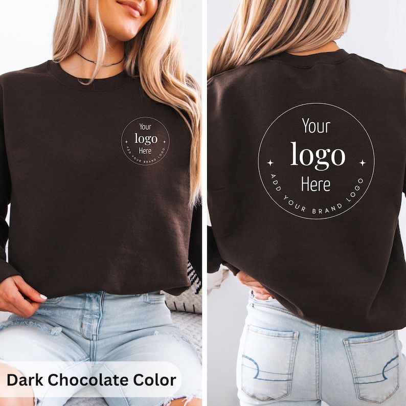 May include: Dark chocolate-colored sweatshirt with a crew neck. The front features a circular logo design with the text "Your logo Here". The back of the sweatshirt also displays the same logo design. The text "Add Your Brand Logo" is included in the design.