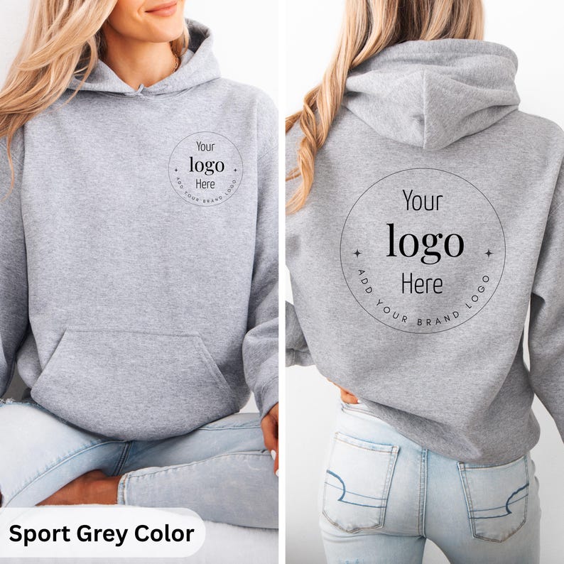 May include: Sport grey hoodie with a front kangaroo pocket and a hood. The front and back of the hoodie feature a circular design with the text "Your logo Here" in a black font. The bottom of the image has the text "Sport Grey Color".