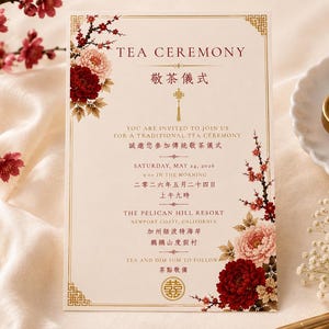 May include: A rectangular invitation card for a tea ceremony featuring bilingual English and Chinese text, gold border accents, and floral illustrations of red and pink peonies and cherry blossoms on a cream-coloured background with a double happiness symbol.