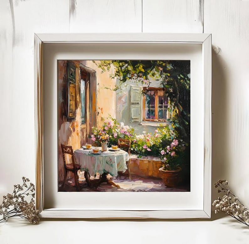 May include: A painting depicting a patio scene with a table set for two, surrounded by lush greenery and flowers. The table has a white tablecloth and two chairs. A window with a view of a garden is visible in the background.