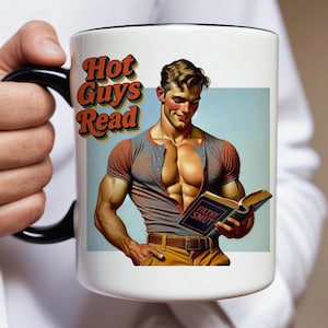 May include: White ceramic mug with a black handle and rim. The mug features the text "Hot Guys Read" in orange and brown, along with an illustration of a muscular man reading a book titled "Filthy Smut".