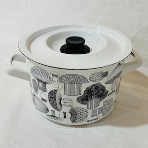 May include: White enamel pot with a lid and two handles. The pot features a black and white mushroom pattern around the exterior. The lid has a black knob. A charming kitchenware item.