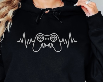 May include: Black hooded sweatshirt with a white graphic of a video game controller and a heartbeat line.