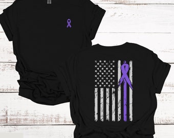 May include: Black t-shirt with a purple ribbon on the front and a distressed American flag with a purple ribbon on the back.