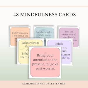 May include: A set of 48 mindfulness cards featuring pastel-colored squares with rounded corners and black text. The cards display various phrases such as Today's mantra: I am here, I am now, and Bring your attention to the present; let go of past worries.