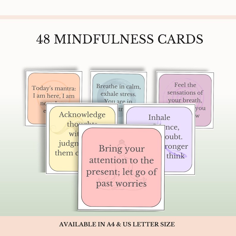 May include: A set of 48 mindfulness cards featuring pastel-colored squares with rounded corners and black text. The cards display various phrases such as Today's mantra: I am here, I am now, and Bring your attention to the present; let go of past worries.