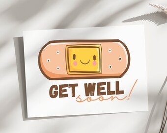 May include: A white card with a cartoon band-aid with a smiling face. The text "GET WELL soon!" is written in brown letters below the band-aid.