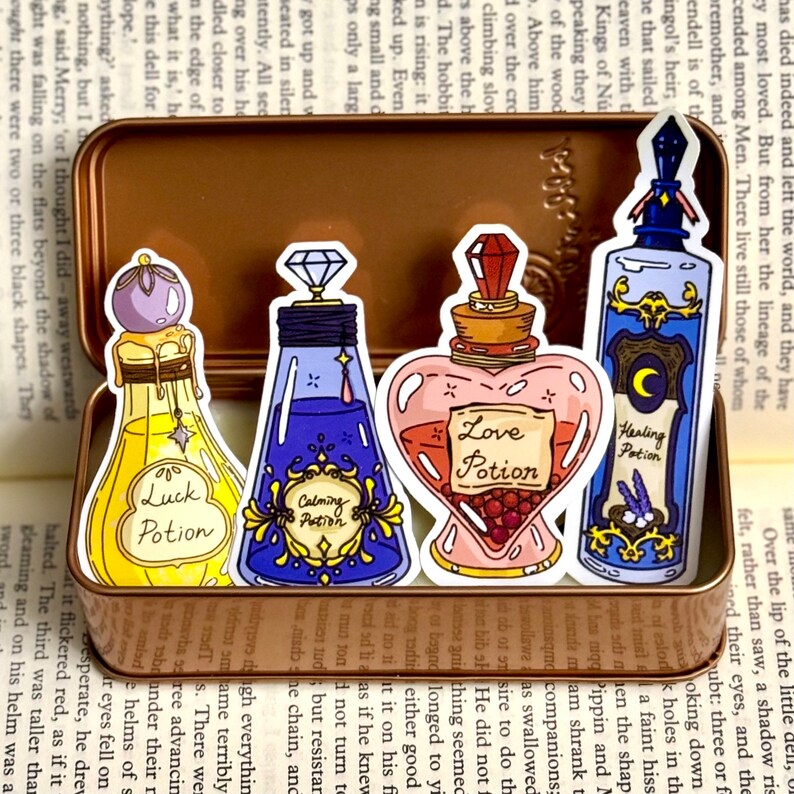 May include: Four colorful glass potion bottles with cork stoppers and labels. The labels read "Luck Potion", "Calming Potion", "Love Potion", and "Healing Potion".