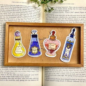 May include: Four colorful glass potion bottles with cork stoppers and labels. The labels read "Luck Potion", "Calming Potion", "Love Potion", and "Healing Potion".