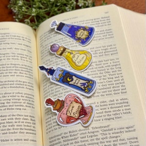 May include: Four colorful potion bottle stickers with different labels: Healing Potion, Luck Potion, Love Potion, and a blue potion with a crown and the text "Royal Remedy".
