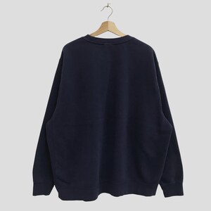 May include: A dark blue long-sleeved sweatshirt with a crew neck.