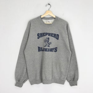May include: Gray sweatshirt with a navy blue graphic of a bird with the text "SHEPHERD BLUEJAYS" on the front.
