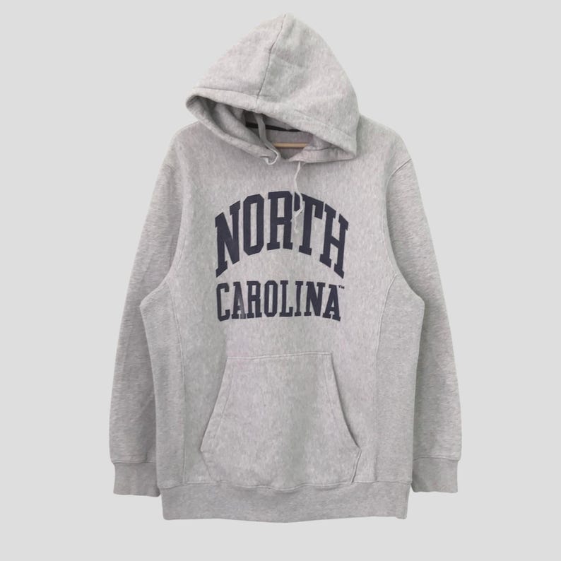 May include: A gray hooded sweatshirt with the text "NORTH CAROLINA" printed in navy blue.