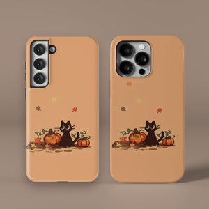 May include: A phone case with a black cat and pumpkins on a brown background. The case has a camera cutout and a black cat with orange pumpkins.