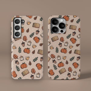 May include: Two phone cases with a fall-themed design. The cases are beige with a pattern of pumpkins, leaves, acorns, coffee cups, and books. The cases have a cutout for the camera lens.