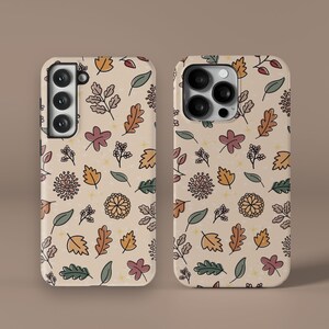 May include: Two phone cases with a beige background and a pattern of leaves, flowers, and stars in shades of brown, orange, red, and green.
