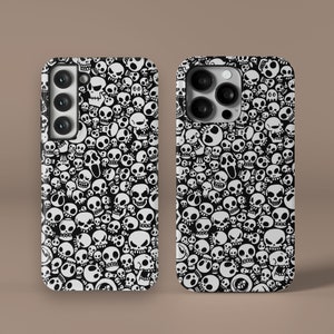May include: Two black phone cases with a white skull pattern. The cases are designed for a phone with a triple camera lens.
