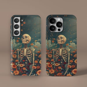 May include: Two phone cases featuring a dark blue background with a floral design. The design includes a skeleton with a skull and crossbones, surrounded by colourful flowers. The cases have a camera cutout and a cutout for the phone's buttons.