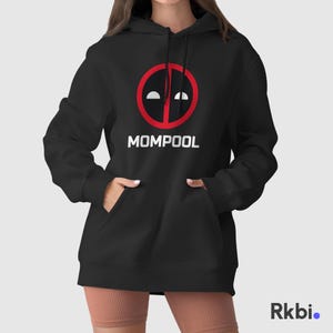 May include: Black hooded sweatshirt with a red Deadpool logo and the text "MOMPOOL" in white.