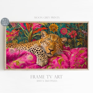 May include: A digital art print featuring a sleeping leopard on a pink and green floral patterned pillow. The leopard is surrounded by lush greenery and flowers. The print is framed in a light wood frame. "MOON GREY PRINTS" and "FRAME TV ART 3840 X 2160 PIXELS" are printed below the image.