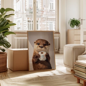 May include: A framed wall art print featuring a realistic illustration of a brown otter with dark eyes holding a small roll of white toilet paper in its paws. The otter is depicted from the chest up against a neutral, light-colored background.