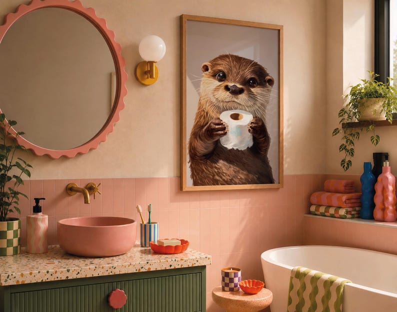 May include: A framed wall art print featuring a brown otter holding a roll of white toilet paper. The artwork is displayed in a bathroom with a pink scalloped mirror, a pink vessel sink, a green vanity, and a white bathtub with a green wavy towel.