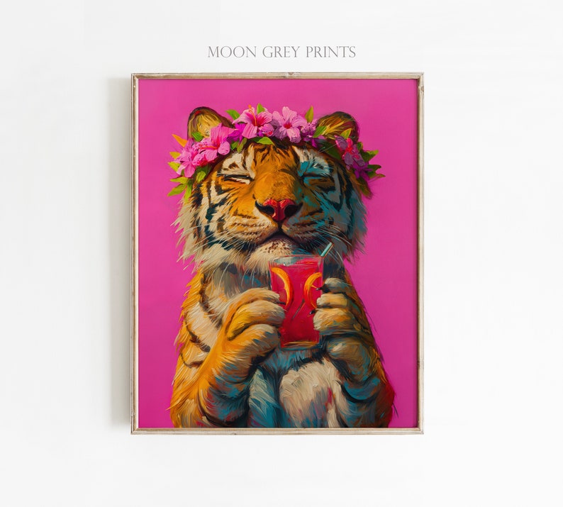 May include: A framed art print titled MOON GREY PRINTS featuring an orange and black tiger with closed eyes wearing a pink hibiscus flower crown. The tiger holds a glass of red liquid with orange slices against a solid bright pink background.