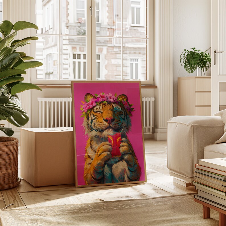 May include: A framed wall art print featuring a tiger with closed eyes wearing a pink flower crown. The tiger is holding a glass of pink liquid with a straw against a solid magenta background. The artwork is displayed in a light wood frame.