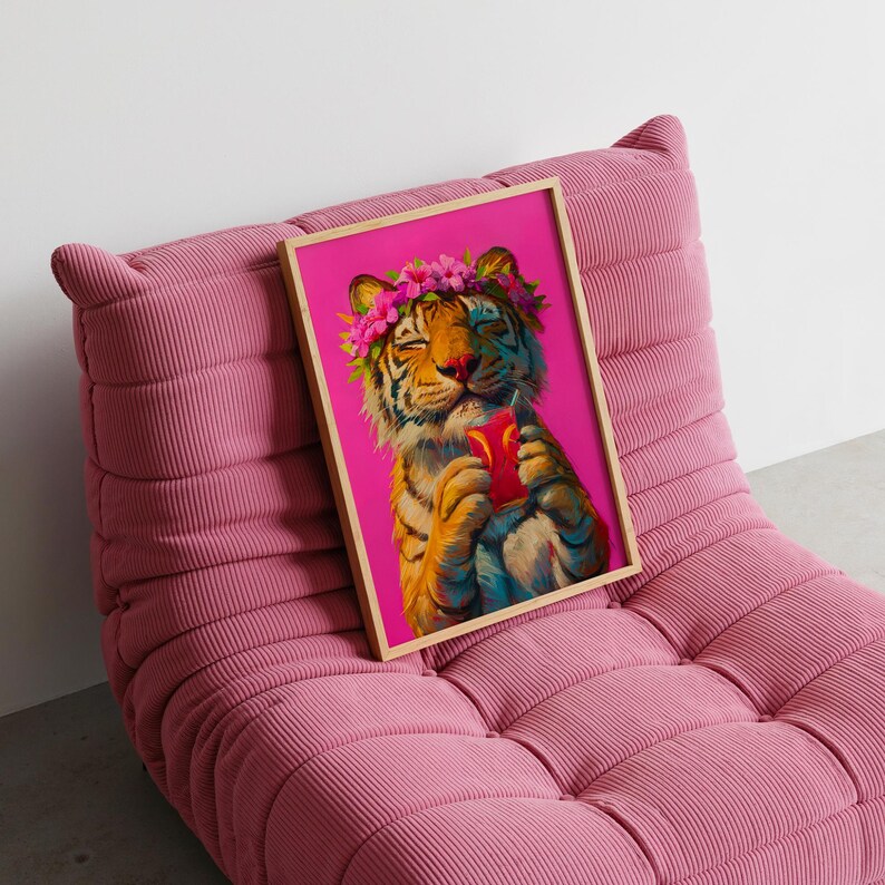 May include: A framed art print featuring a tiger with a pink flower crown on its head, holding a red drink with a straw against a vibrant magenta background. The tiger has its eyes closed and is depicted in a painterly style with orange and black stripes.