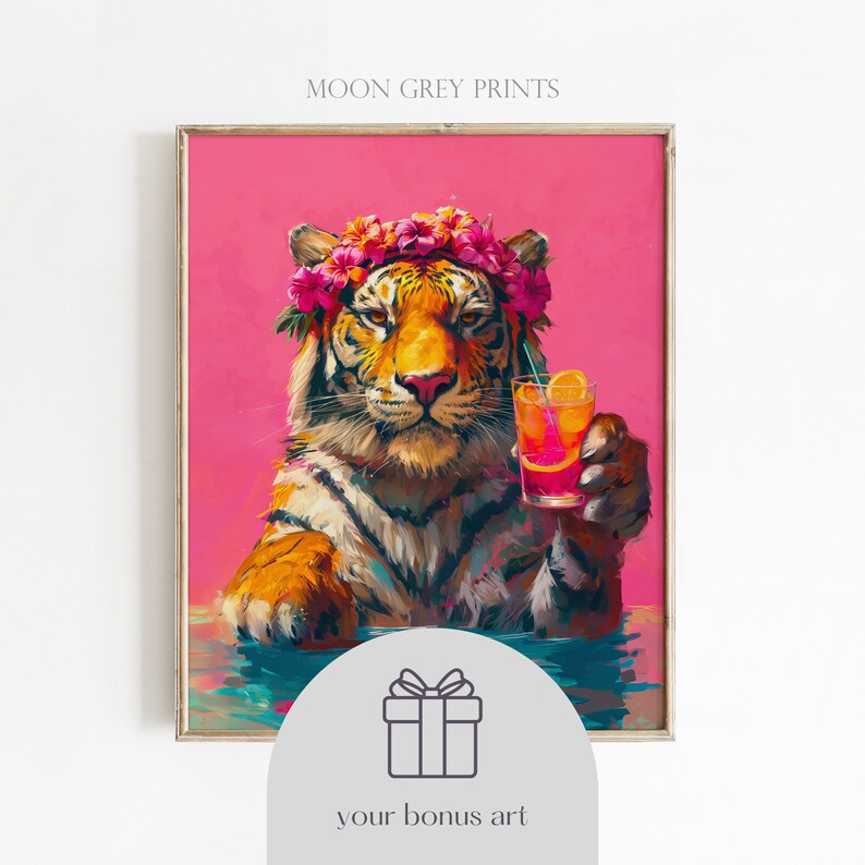May include: A framed art print titled MOON GREY PRINTS featuring a tiger wearing a crown of pink and orange flowers, holding a glass of orange liquid with a slice of citrus and a straw, set against a vibrant pink background with water below.