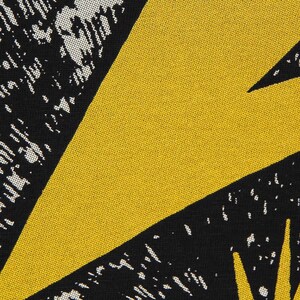 May include: A textile fabric featuring a bold geometric pattern with large, solid mustard yellow triangular shapes contrasted against black sections. The black areas are filled with a white, speckled, stippled texture that creates a grainy, distressed visual effect across the surface of the woven material.
