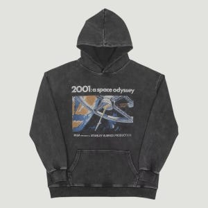 May include: Dark gray hoodie featuring a front graphic from the film "2001: A Space Odyssey." The graphic includes the film's title and a space scene. The hoodie has a drawstring hood and a kangaroo pocket.