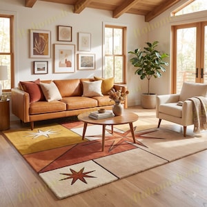 May include: A rectangular area rug featuring a geometric design with large star motifs in shades of mustard yellow, burnt orange, and cream. The rug is positioned on a light wood floor beneath a round wooden coffee table in a living room setting.