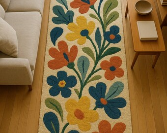 May include: A rectangular floral rug with a cream background and a repeating pattern of colorful flowers and leaves. The flowers are in shades of yellow, orange, and blue, with green leaves. The rug is placed on a hardwood floor.
