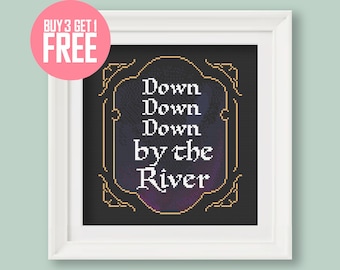 May include: Cross stitch pattern featuring a black background with a gold frame and the text "Down Down Down by the River" in white.