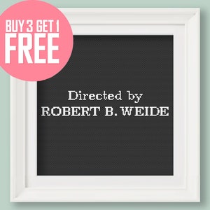 May include: A framed black and white cross-stitch design with the text "Directed by ROBERT B. WEIDE" in white. The frame is white with a simple design.