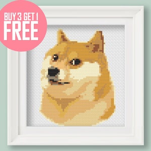 May include: A framed cross-stitch pattern of a Shiba Inu dog with a white background. The dog is looking to the left with a slightly confused expression. The frame is white with a simple design.
