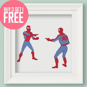 Puede incluir: Patrón de punto de cruz con dos figuras de Spider-Man, rojo y azul, enfrentadas. El patrón está enmarcado en un marco blanco.