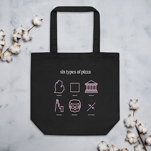 May include: Black tote bag with white text that reads "six types of pizza". The bag features six pink line drawings of different pizza styles, including Detroit, Square, Sicilian, Chicago, Grandma, and Thin Crust.