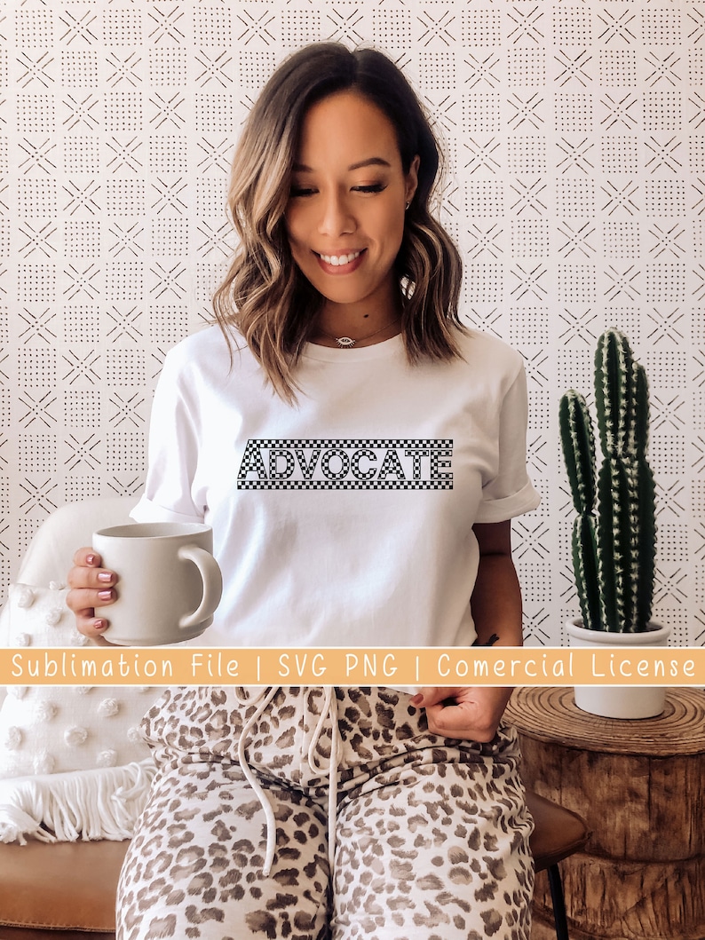May include: White t-shirt with the word "ADVOCATE" printed in black and white checkered pattern.