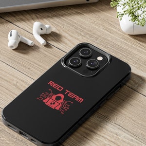 May include: Black phone case with a red "RED TEAM" text and a red graphic of a hooded figure with a lock on a circuit board.